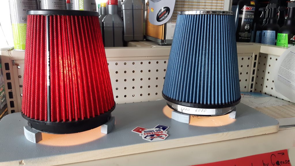 Comparing cold air intake filters with light.